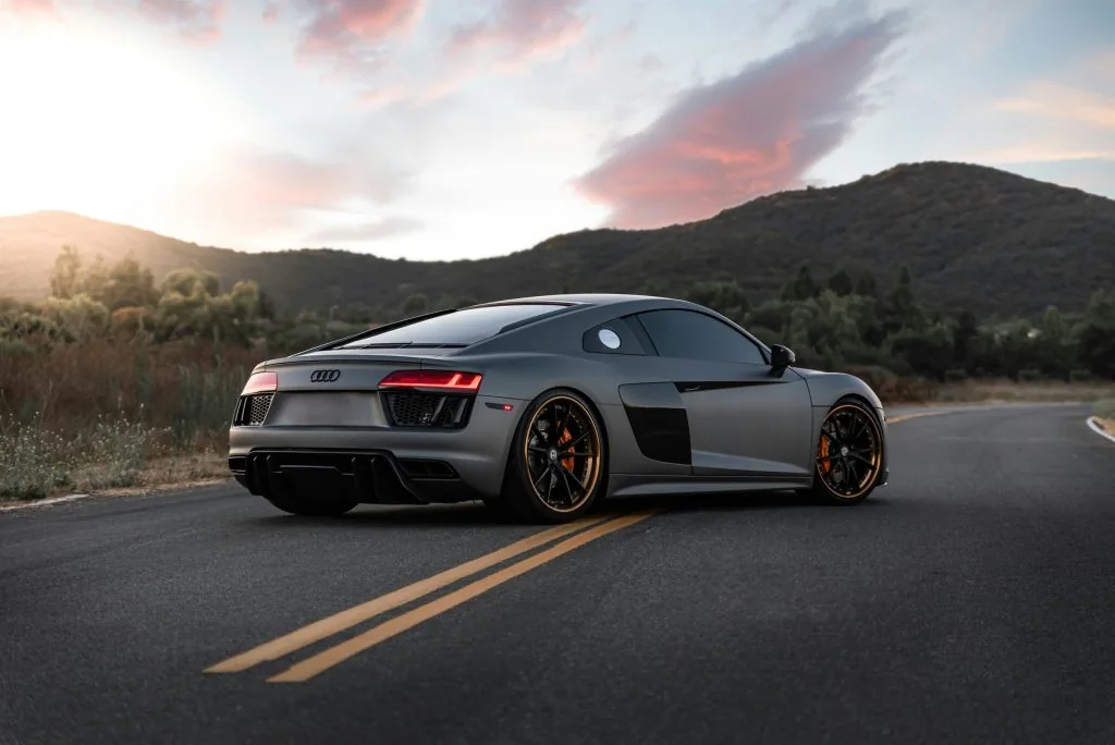 Grey Audi R8 on a mountain road at sunset, delivered for a self-drive stay in Mallorca