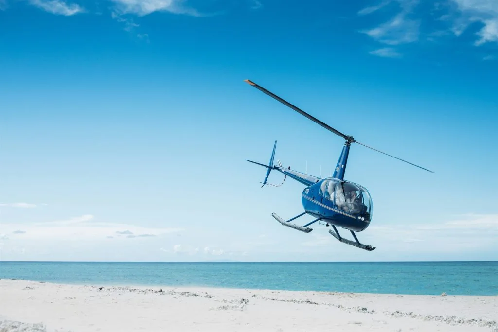 Helicopter flying low over a turquoise Mallorca coastline
