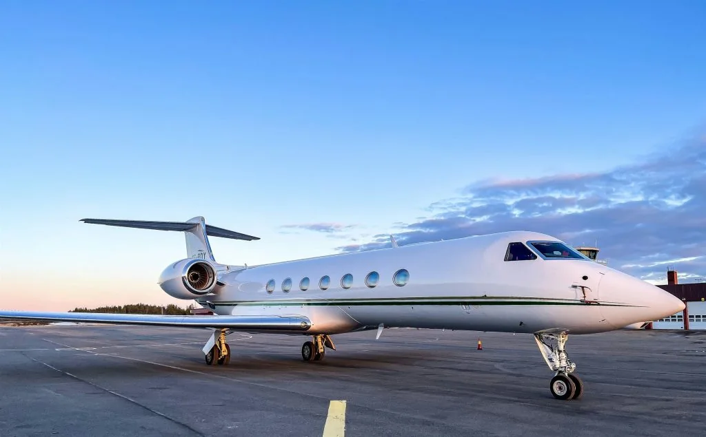 Private jet parked on the tarmac at Palma airport at dusk